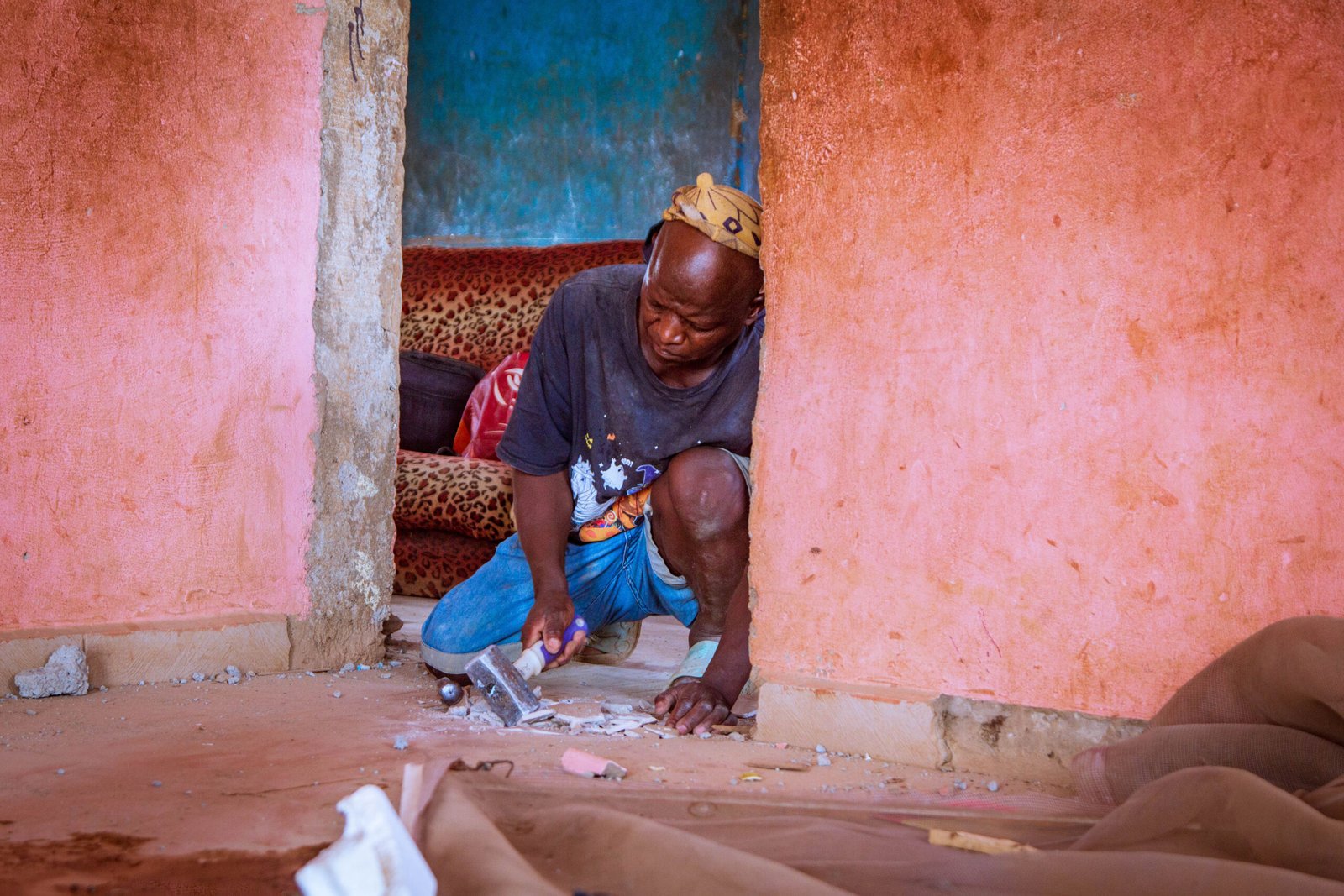 man working on flooring in children support project