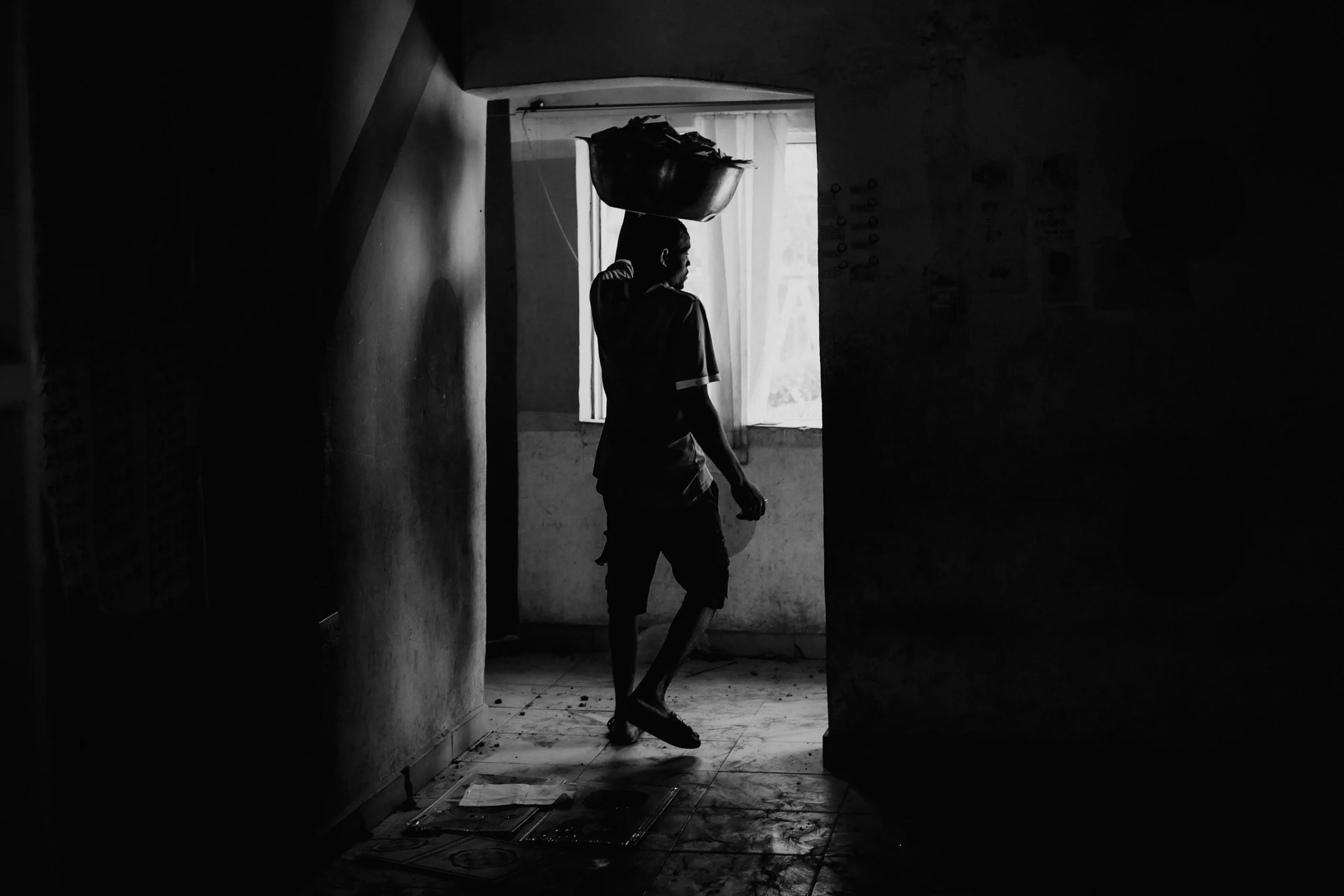 child walking in low light before charity supp\