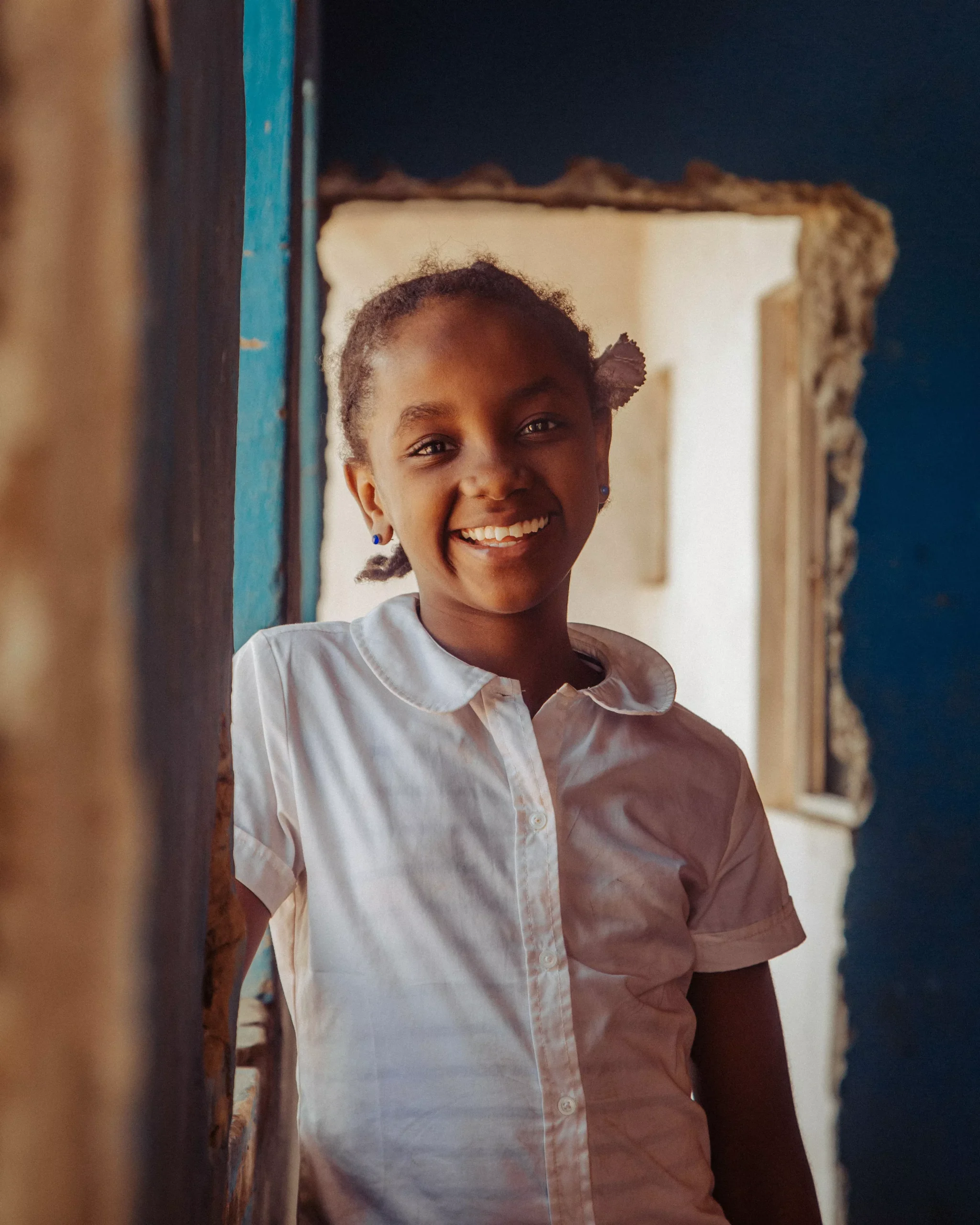 smiling child in need supported by charity program