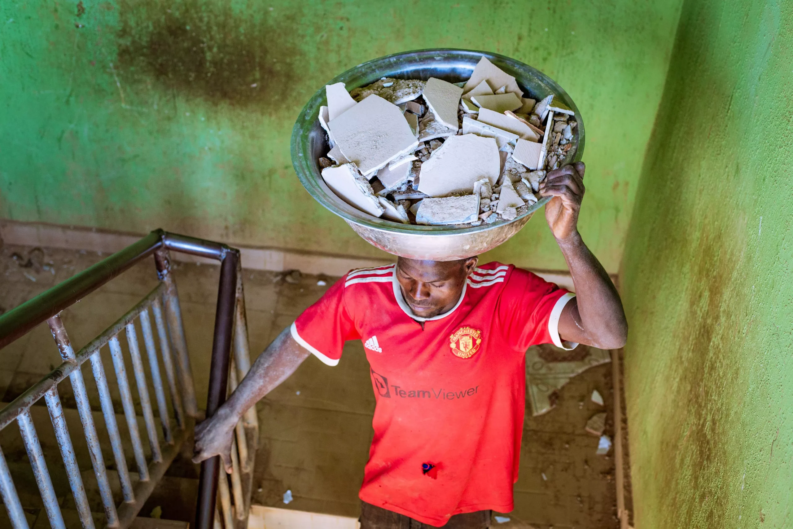 child carrying supplies after receiving support