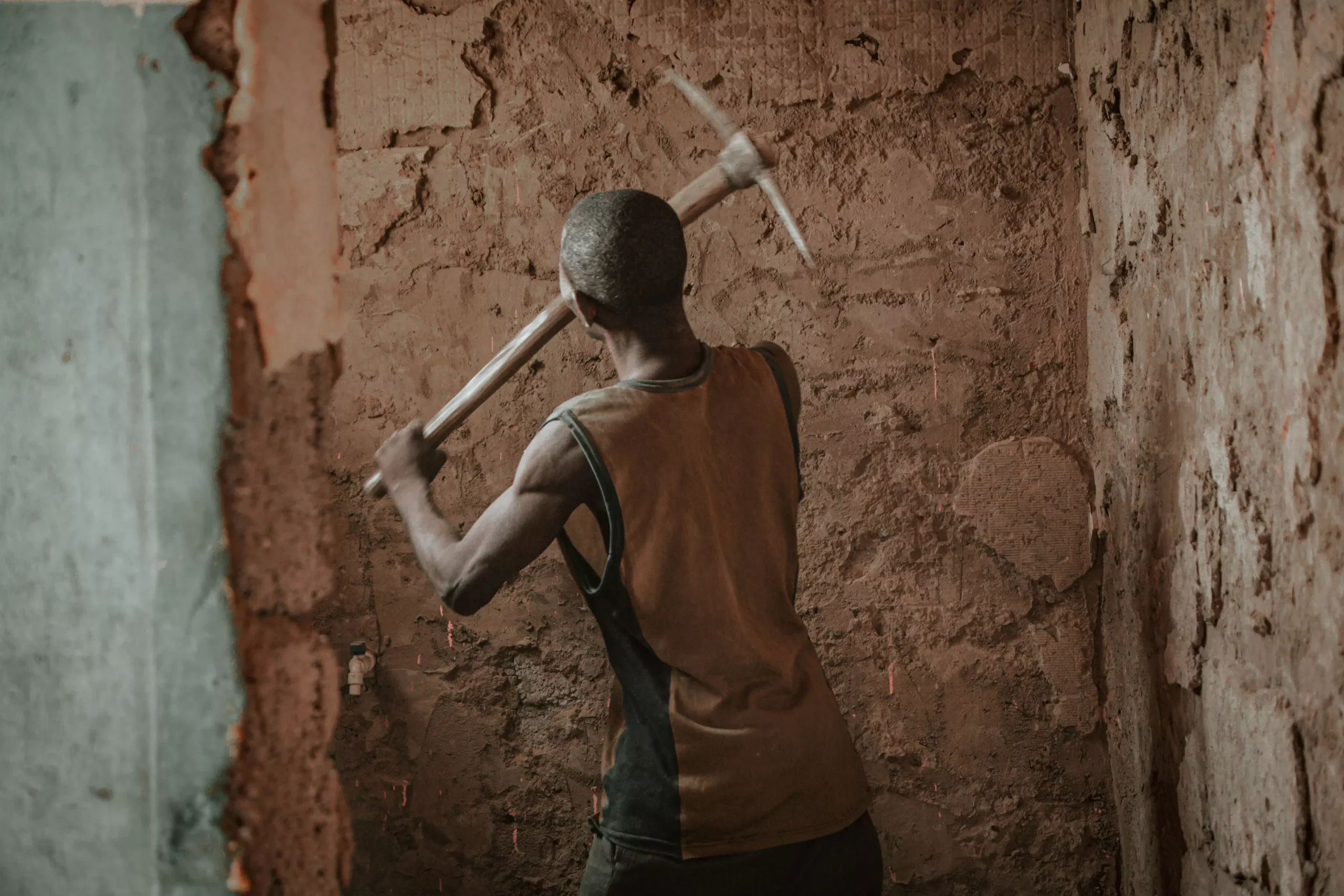 worker repairing walls in children charity project